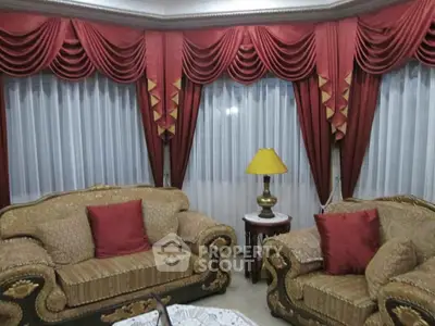 Elegant living room with luxurious drapes and classic furniture, perfect for sophisticated gatherings.