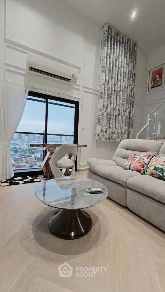 Luxurious living room with stunning city view, elegant decor, and modern furniture in high-rise apartment.