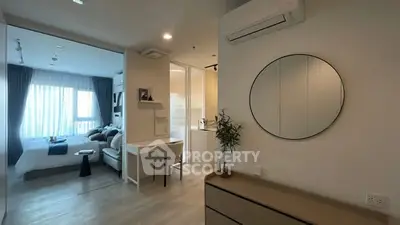 Modern apartment interior with bedroom and study area, featuring sleek design and natural light.