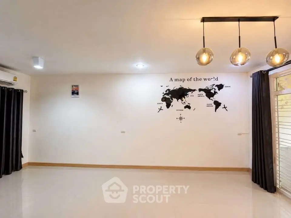 Spacious living room with modern lighting and world map wall decor