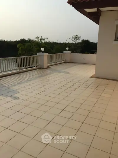 Spacious balcony with scenic view and elegant railing, perfect for outdoor relaxation.