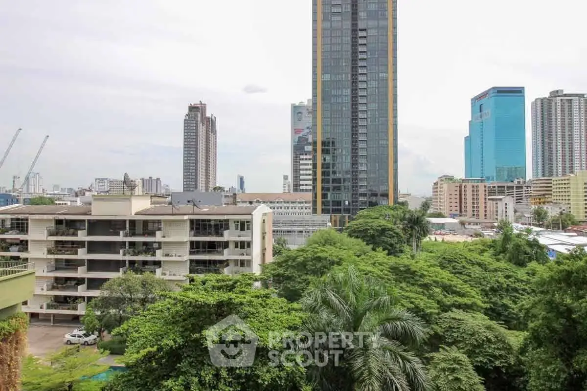 Stunning cityscape view with lush greenery and modern high-rise buildings, perfect for urban living.