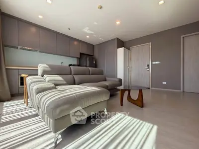 Spacious modern living room with sleek furniture and natural light in a contemporary apartment.