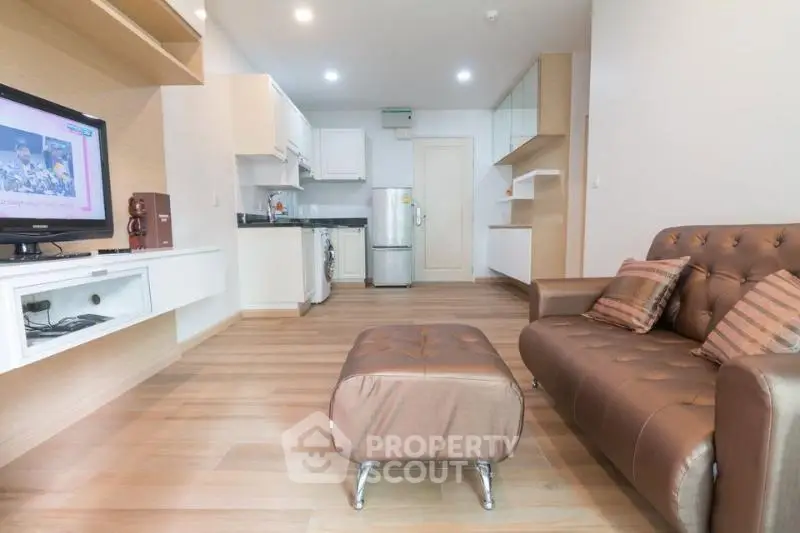 Modern living room with open kitchen layout and stylish furniture