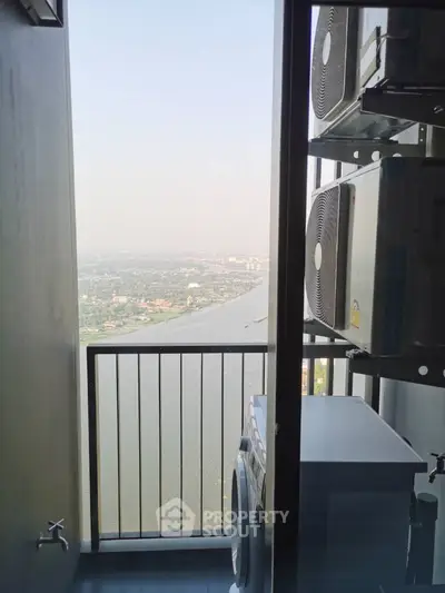 High-rise balcony with river view and laundry appliances