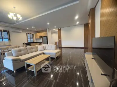 Spacious modern living room with elegant decor and open kitchen layout