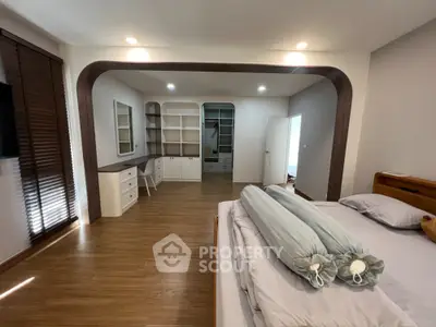 Spacious bedroom with modern wooden flooring and built-in storage solutions