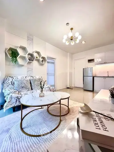 Modern living room with stylish decor and open kitchen layout