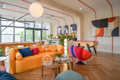 Stylish modern living room with vibrant decor and foosball table