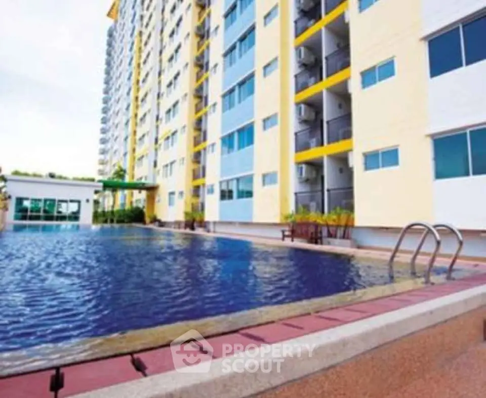 Modern apartment building with inviting pool and vibrant exterior design.