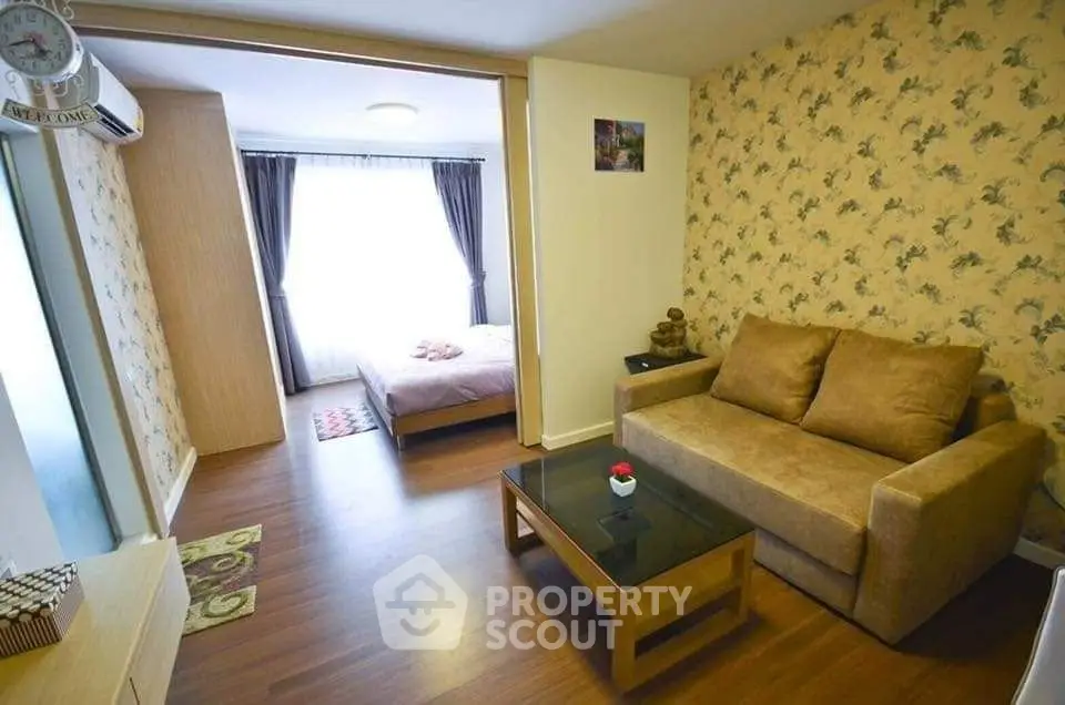 Cozy living room with sofa and bedroom view, perfect for modern living.