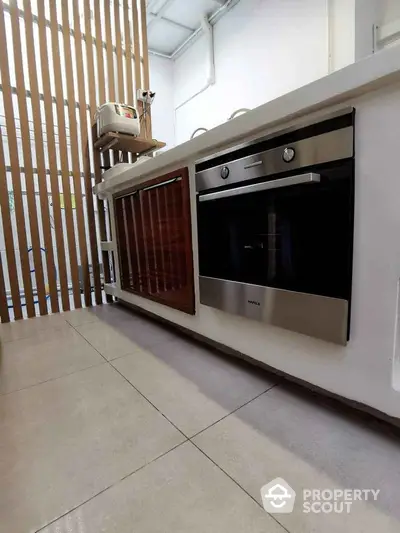 Modern kitchen with built-in oven and sleek design