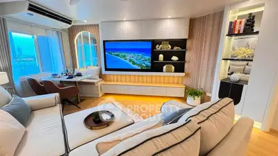 Luxurious modern living room with elegant decor and city view, featuring a large TV and cozy seating area.