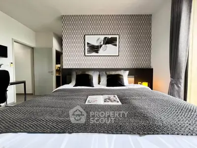 Modern bedroom with stylish decor and cozy bedding in a contemporary apartment.