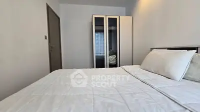 Cozy bedroom with modern wardrobe and comfortable bedding in a stylish apartment.