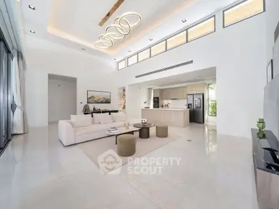 Luxurious open-plan living room with modern kitchen and elegant lighting in a spacious home.
