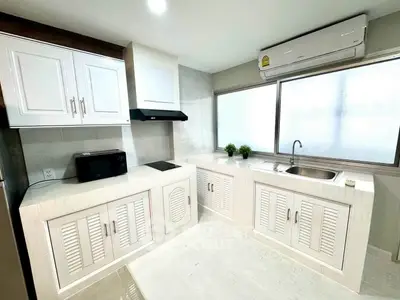 Modern kitchen with sleek cabinetry and large window for natural light