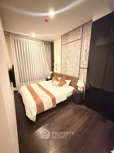 Elegant bedroom with modern decor and large window in upscale apartment