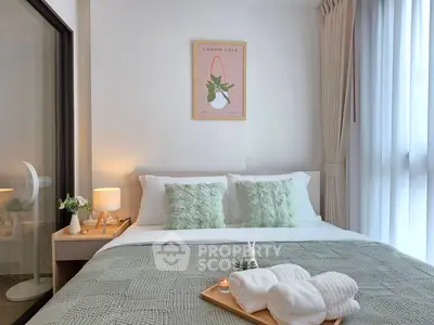 Cozy bedroom with stylish decor and natural light, perfect for relaxation and comfort.