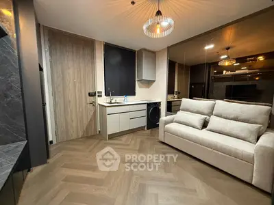 Modern living room with stylish sofa and sleek kitchen corner