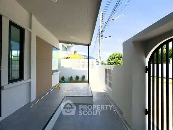 Modern home entrance with sleek design and spacious outdoor area.
