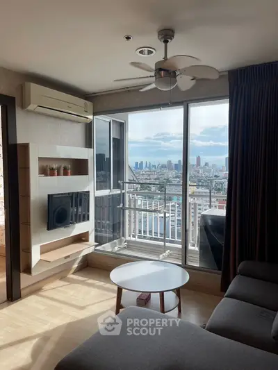 Modern living room with city view, featuring sleek furniture and large windows for natural light.