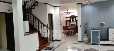 Spacious living area with elegant staircase and dining room, perfect for family gatherings.