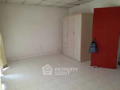 Spacious empty room with wardrobe and tiled floor, ideal for customization.