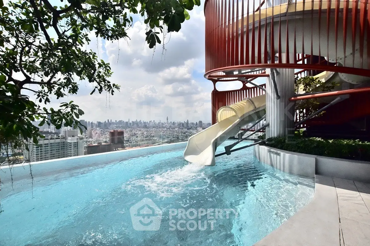 Luxurious rooftop pool with city skyline view and unique slide feature.