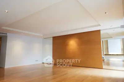 Spacious modern living room with wooden flooring and elegant lighting