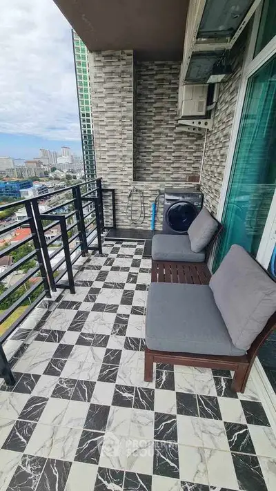 Stylish balcony with seating and city view, perfect for relaxation.