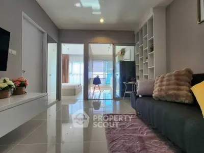 Modern living room with sleek design and open layout, featuring cozy seating and stylish decor.