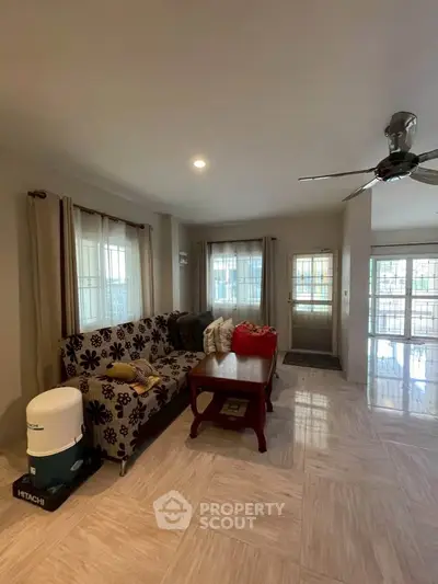 Spacious living room with modern decor and large windows for natural light.