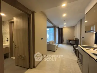 Modern open-layout apartment with sleek kitchen and cozy living area, perfect for urban living.