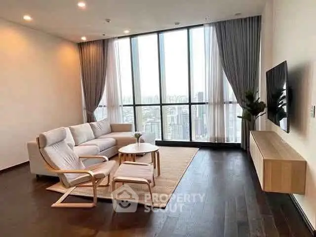 Spacious modern living room with floor-to-ceiling windows and city view