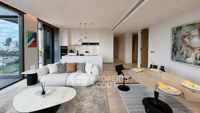 Luxurious modern living room with open kitchen and stunning city view, featuring elegant decor and spacious layout.
