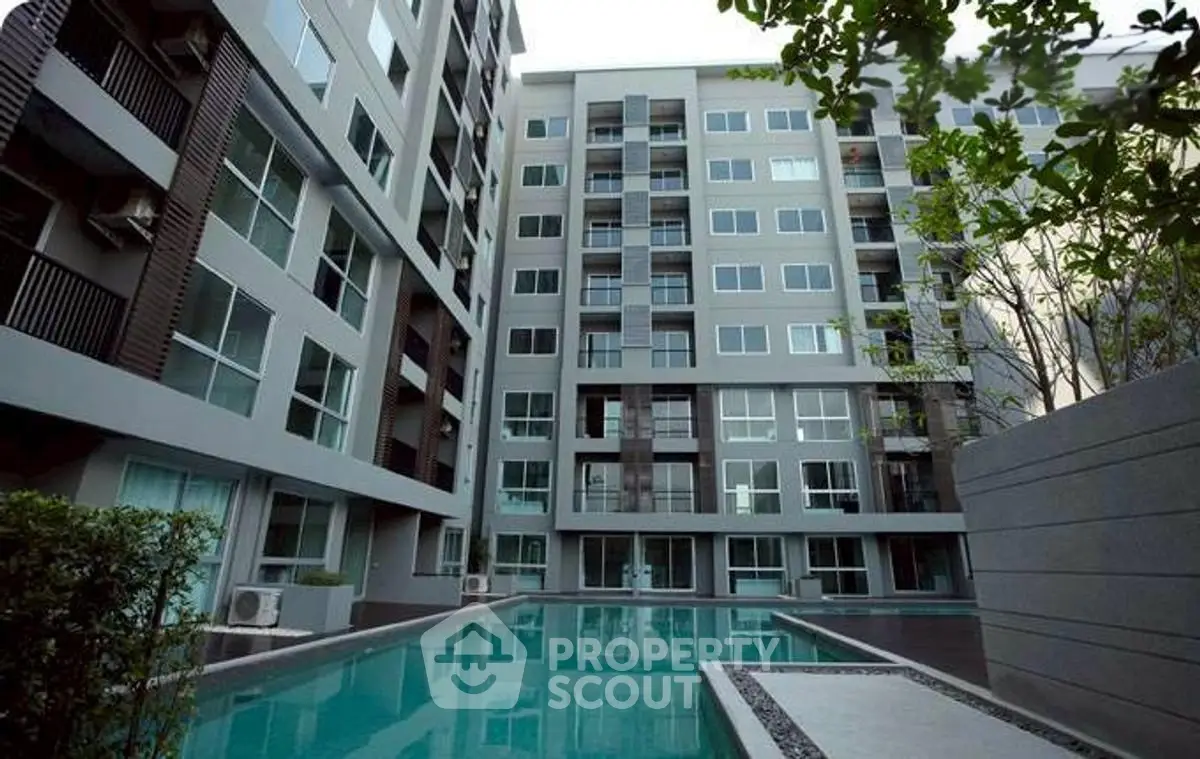 Modern apartment building with a luxurious swimming pool in the courtyard.