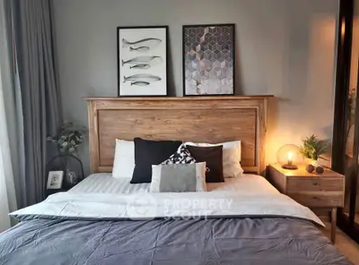 Cozy bedroom with stylish decor and wooden headboard, perfect for relaxation.