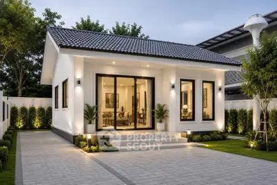 Charming modern bungalow with elegant exterior lighting and lush landscaping.