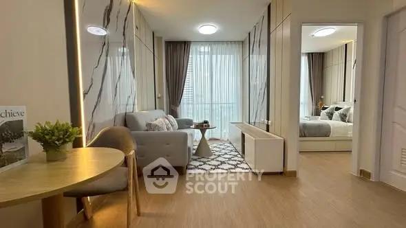 Modern living room with stylish decor and natural light in a contemporary apartment.