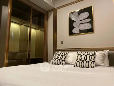 Modern bedroom with stylish decor and cozy bedding in a contemporary apartment.