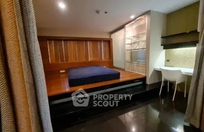 Modern bedroom with elevated platform bed and sleek workspace