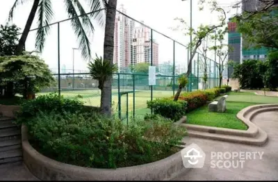 Luxurious urban garden with tennis court and skyline view, perfect for relaxation and recreation.