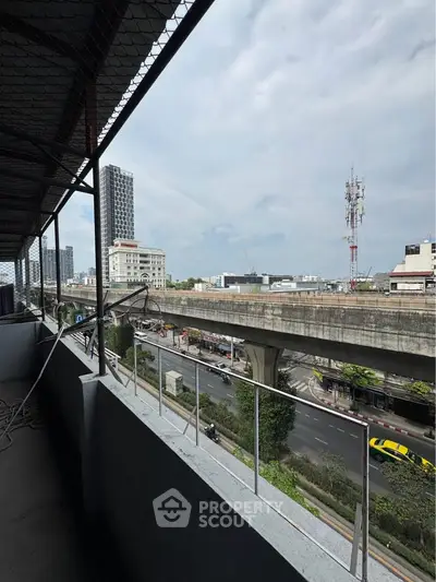 Urban balcony view overlooking highway and cityscape with modern buildings