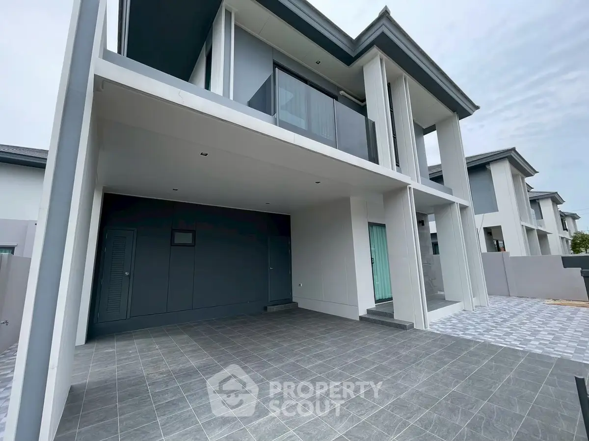Modern two-story house with spacious garage and sleek design.