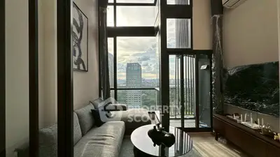 Luxurious living room with floor-to-ceiling windows and stunning city view