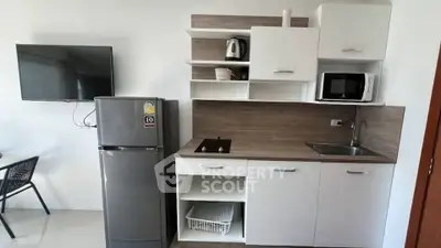 Modern compact kitchen with sleek appliances and stylish cabinetry