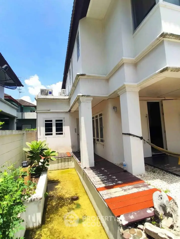 Charming two-story house with garden and patio in sunny neighborhood