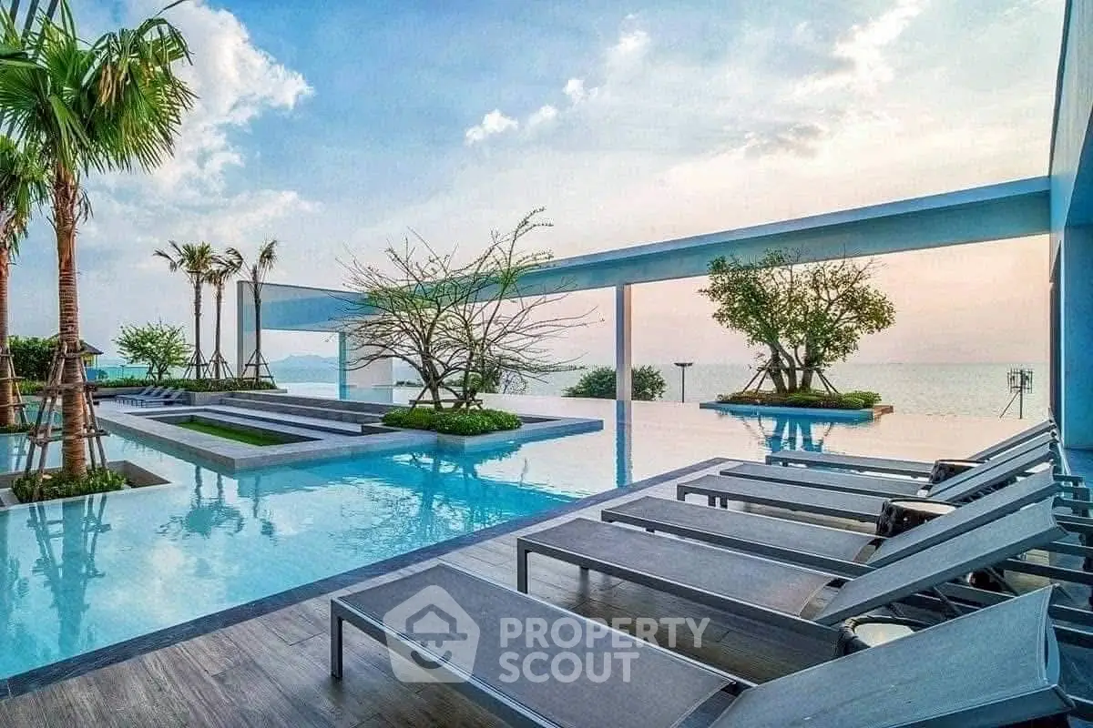 Luxurious rooftop pool with ocean view and modern lounge chairs.