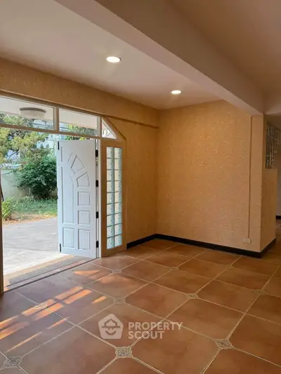 Spacious interior with elegant tile flooring and natural light from open door